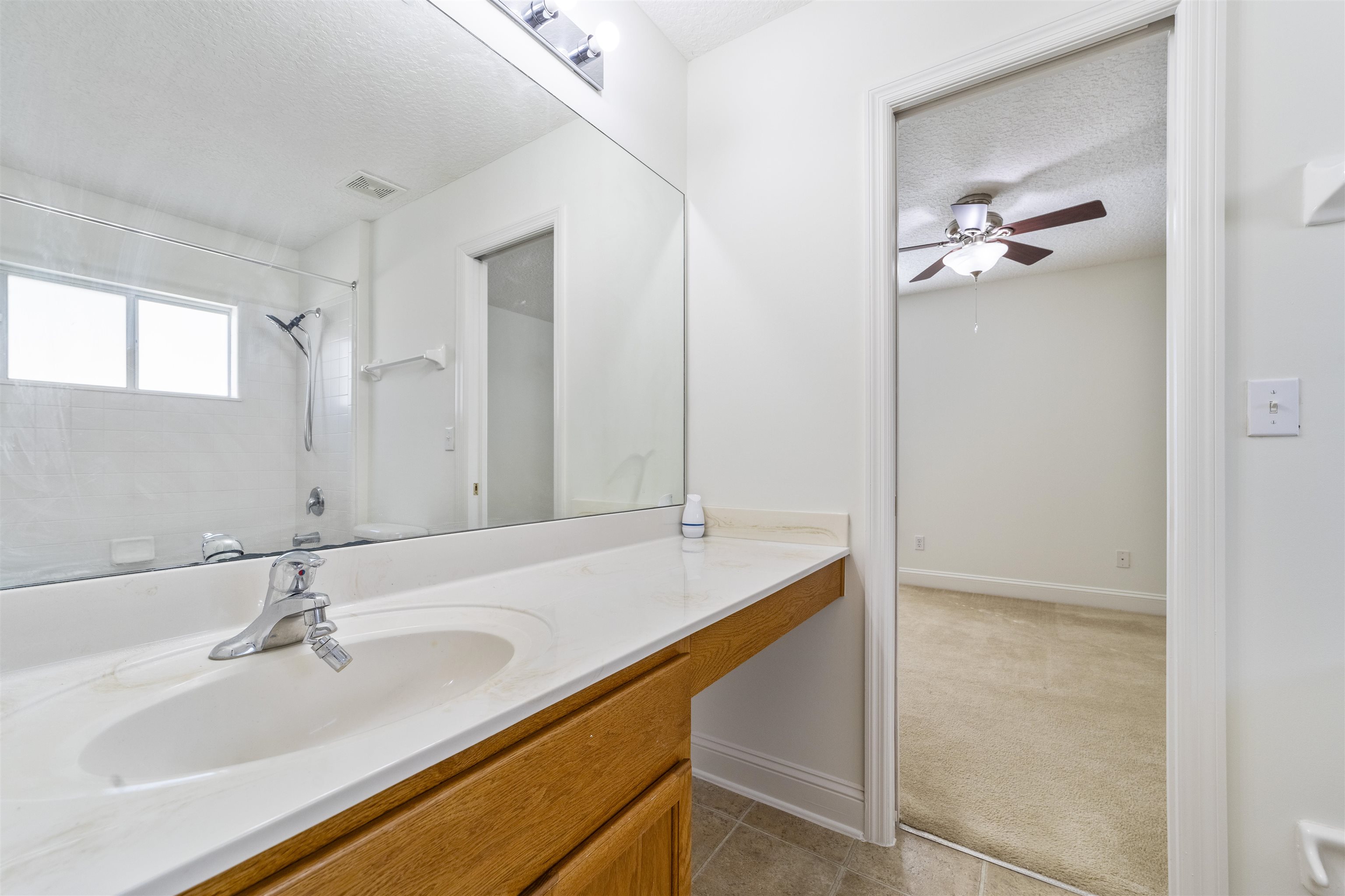 145 Whisper Ridge Drive St. Augustine, FL 32092 - Photo 28 of 32 a bathroom with a sink and a mirror