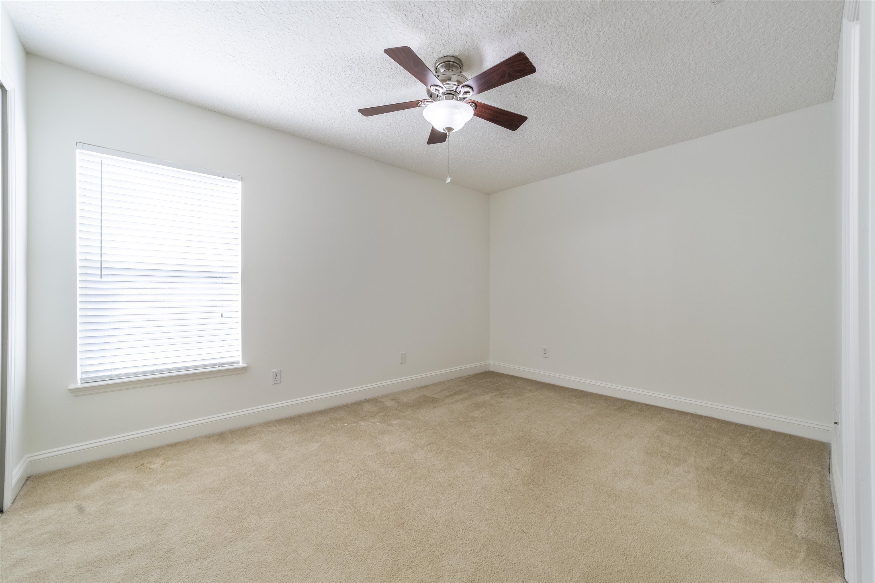 145 Whisper Ridge Drive St. Augustine, FL 32092 - Photo 30 of 32 an empty room with ceiling fan and window