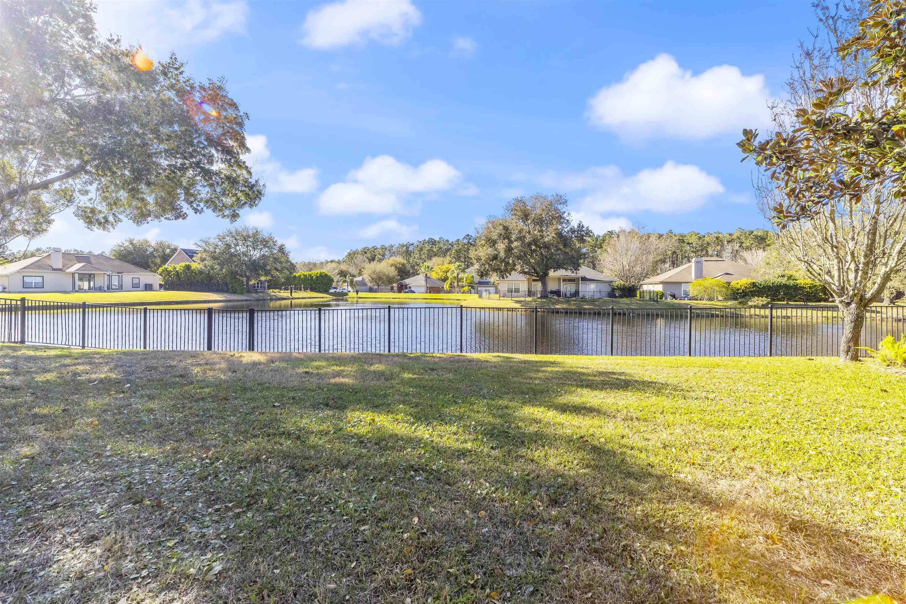 145 Whisper Ridge Drive St. Augustine, FL 32092 - Photo 3 of 32 a view of a lake with houses in the back