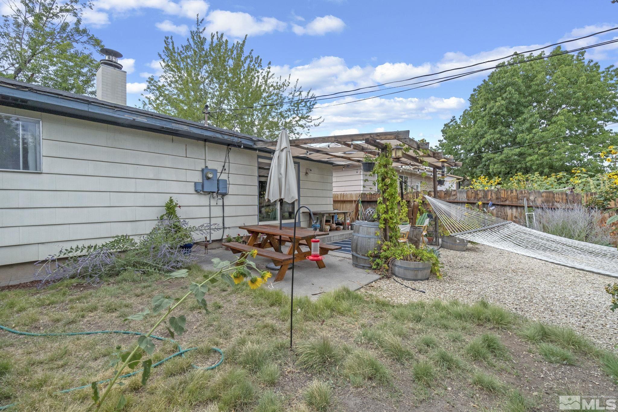 1480 Rayburn Drive Reno, NV 89503 - Photo 22 of 29 a view of backyard with outdoor seating and plants