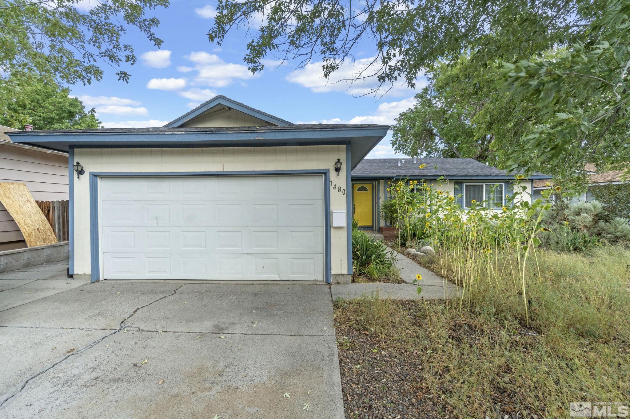 1480 Rayburn Drive Reno, NV 89503 - Photo 26 of 29 a front view of a house with a yard and garage