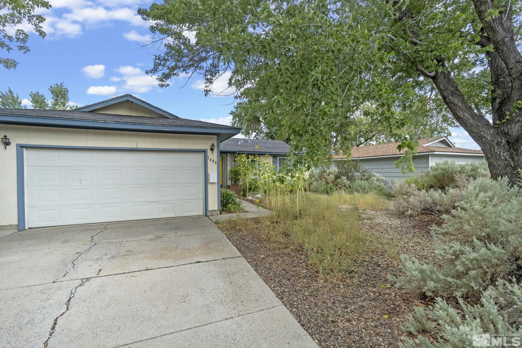 1480 Rayburn Drive Reno, NV 89503 - Photo 27 of 29 a front view of a house with a yard and garage