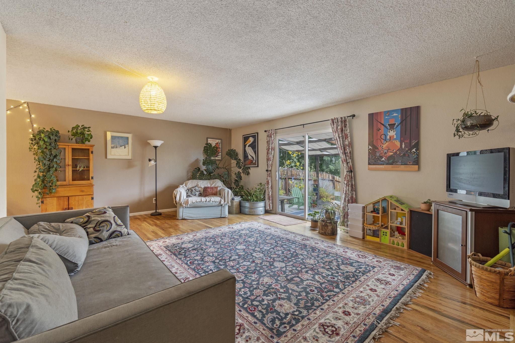 1480 Rayburn Drive Reno, NV 89503 - Photo 3 of 29 a living room with furniture and a flat screen tv
