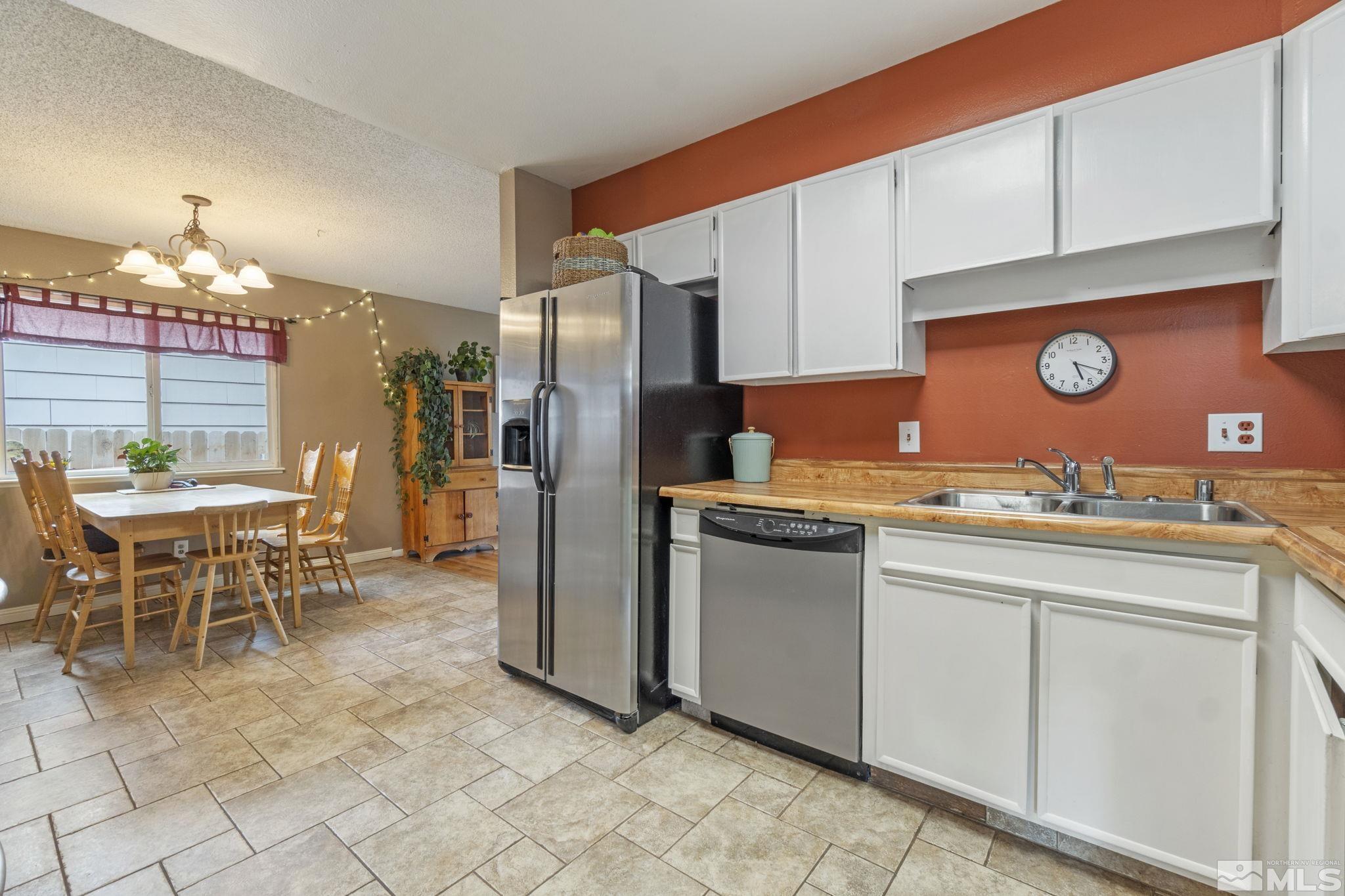 1480 Rayburn Drive Reno, NV 89503 - Photo 7 of 29 a open kitchen with granite countertop a sink cabinets and refrigerator