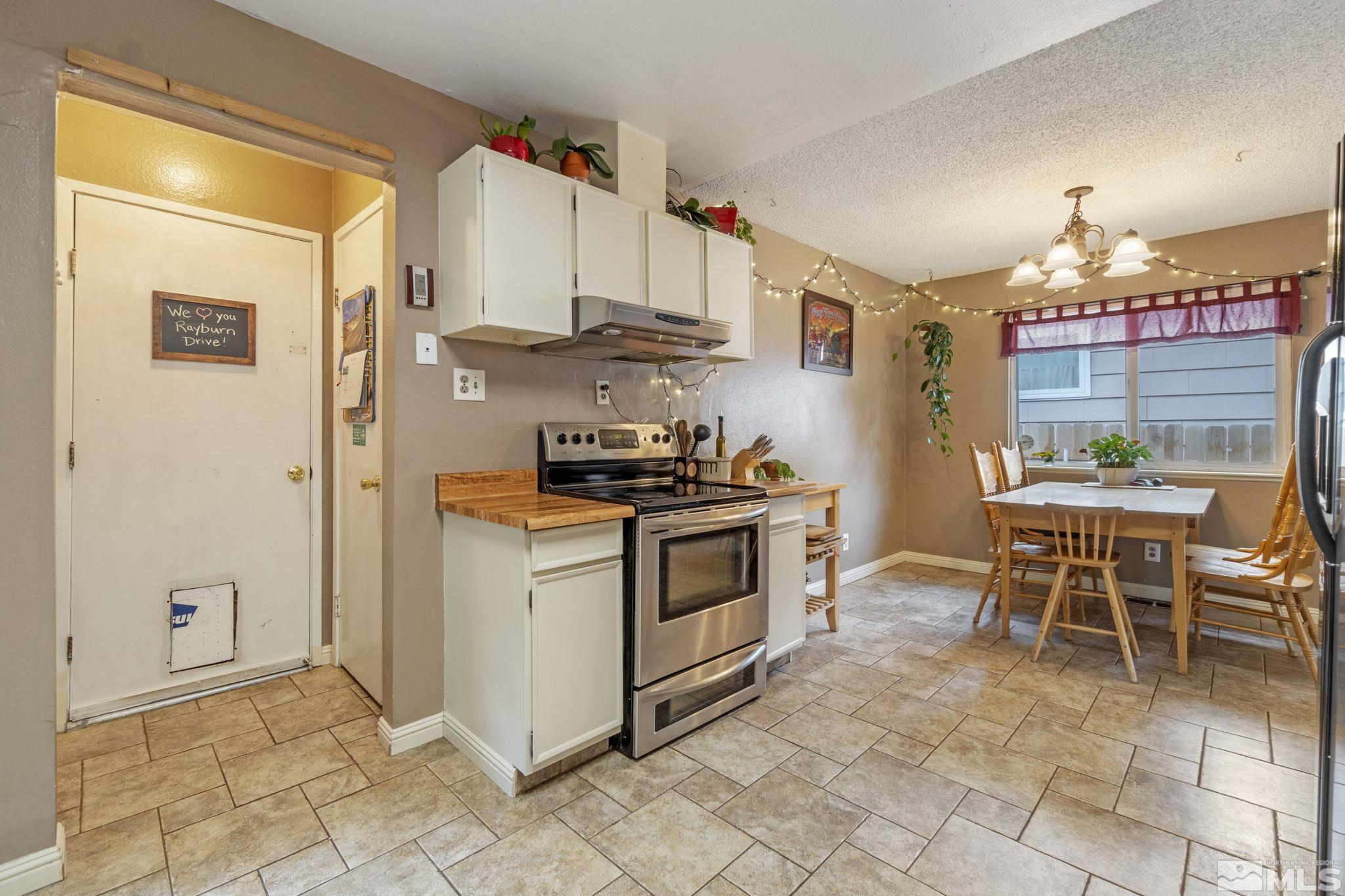 1480 Rayburn Drive Reno, NV 89503 - Photo 8 of 29 a kitchen with stainless steel appliances a stove a sink and a refrigerator