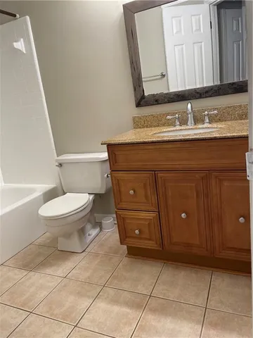 a bathroom with a toilet a sink and bathtub