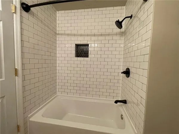 a kitchen with granite countertop a sink stove and microwave