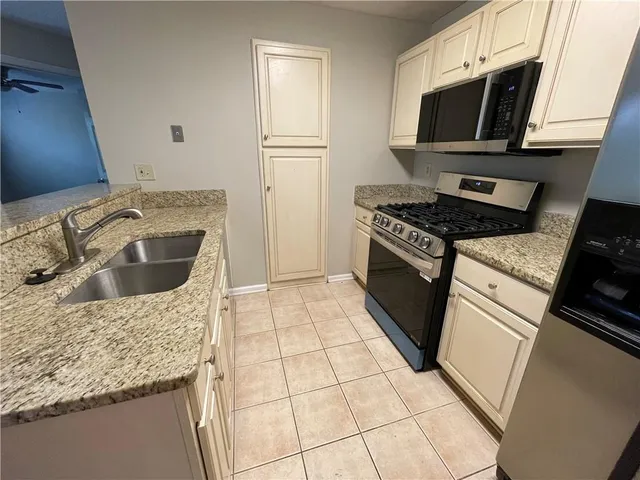 a kitchen with a refrigerator sink and microwave