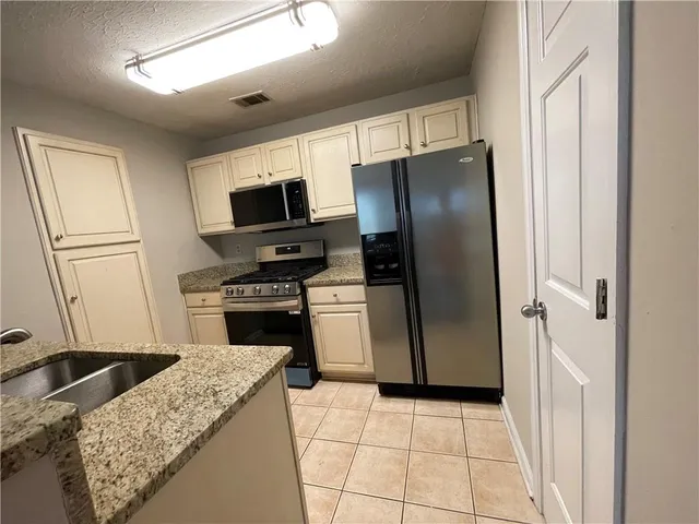 a kitchen with a stove microwave and refrigerator