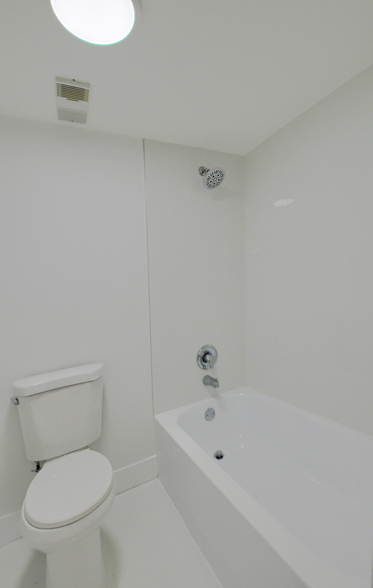 9170 Southwest 14th Street, Unit 4405 Boca Raton, FL 33428 - Photo 19 of 48 a white toilet sitting next to a bath tub