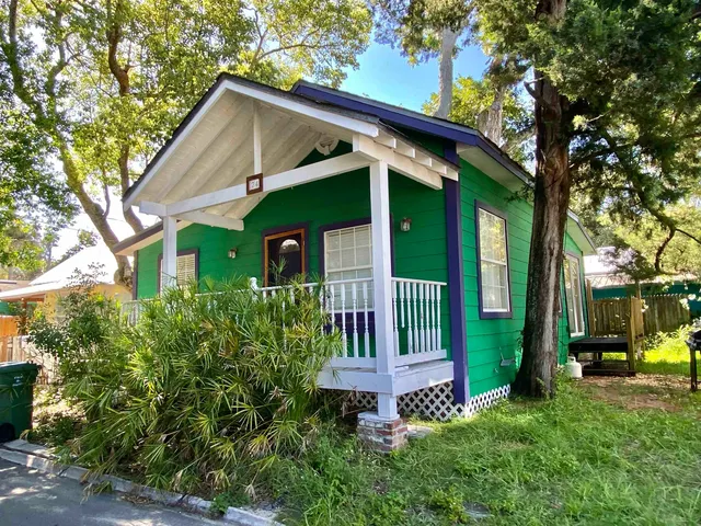 a view of a house with a yard and plants