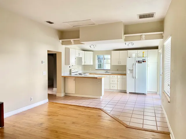 a kitchen with granite countertop a refrigerator and a sink