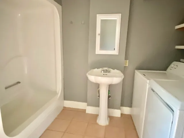 a bathroom with a sink a bath tub and shower