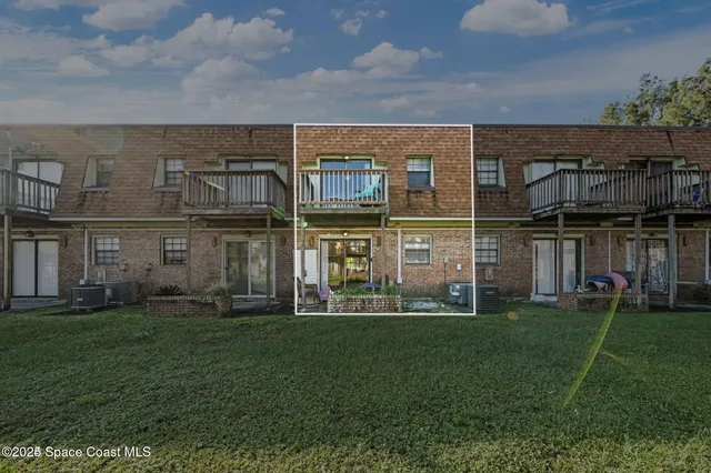 a view of a building with a yard