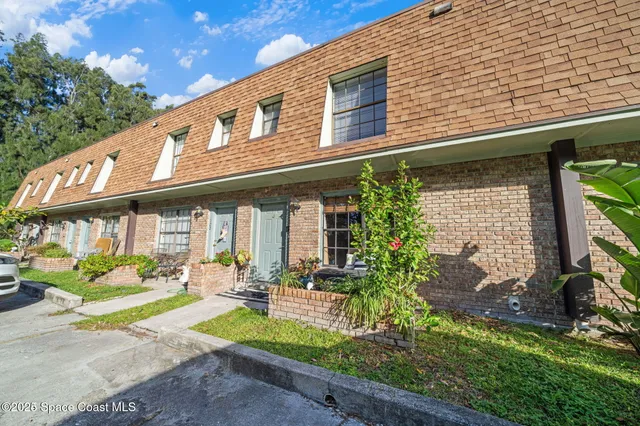 a front view of a brick building with many windows