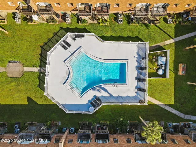 an aerial view of a house with a swimming pool yard and outdoor seating