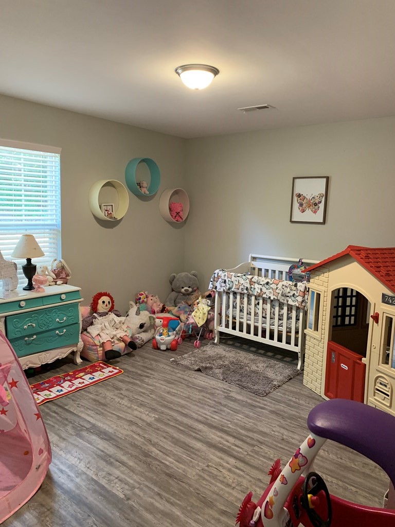 28308 Rhea County Highway Spring City, TN 37381 - Photo 14 of 23 a bedroom with furniture and a wooden floor
