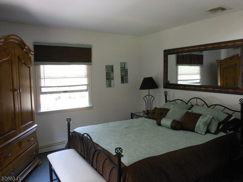 206 Ryerson Road Lincoln Park, NJ 07035 - Photo 12 of 23 a bedroom with a bed and a tv