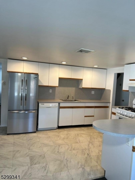 206 Ryerson Road Lincoln Park, NJ 07035 - Photo 17 of 23 a kitchen with stainless steel appliances a sink and a stove