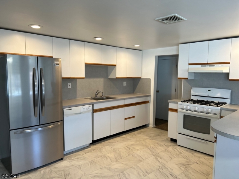 206 Ryerson Road Lincoln Park, NJ 07035 - Photo 20 of 23 a kitchen with stainless steel appliances granite countertop a refrigerator sink and stove