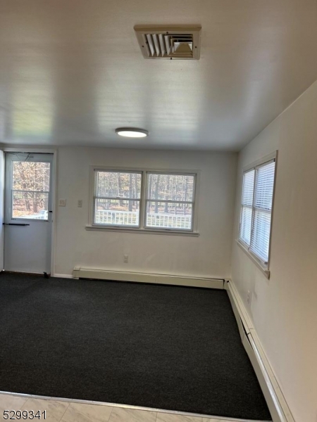 206 Ryerson Road Lincoln Park, NJ 07035 - Photo 21 of 23 an empty room with wooden floor and windows