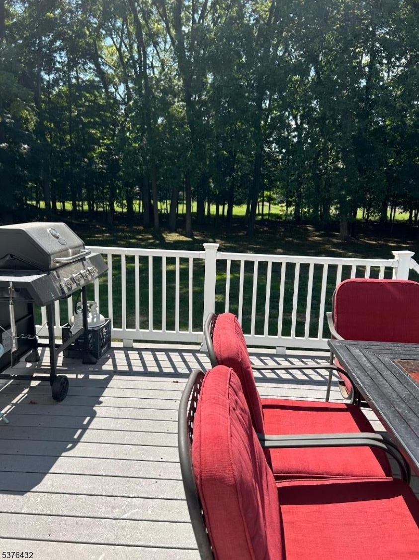 206 Ryerson Road Lincoln Park, NJ 07035 - Photo 23 of 23 a balcony with wooden floor and outdoor seating