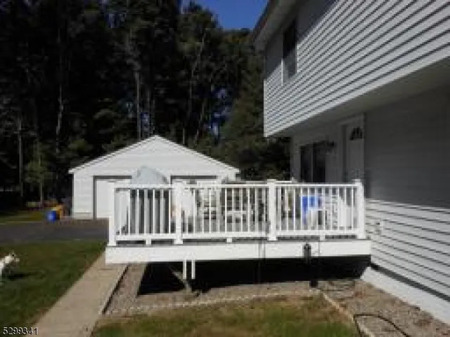 a view of balcony with wooden floor and outdoor seating
