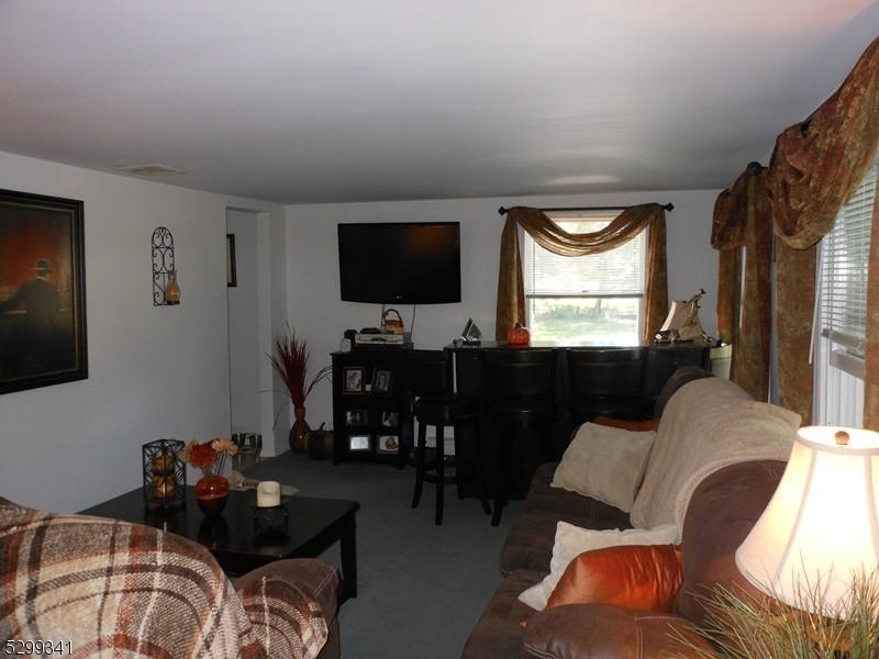 206 Ryerson Road Lincoln Park, NJ 07035 - Photo 7 of 23 a living room with furniture and a flat screen tv