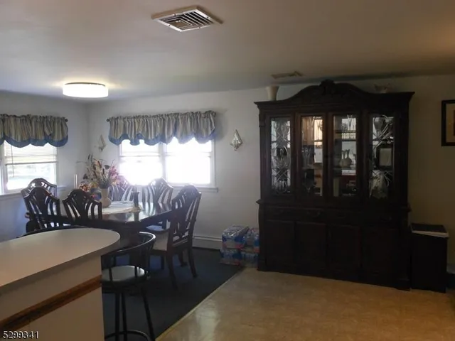 a view of a dining room with furniture and window