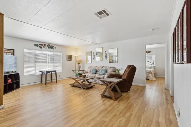 a living room with furniture and a wooden floor