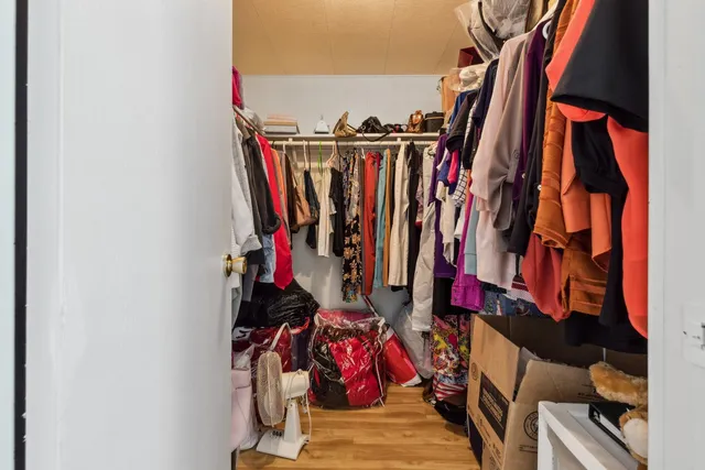 a view of walk in closet with clothes