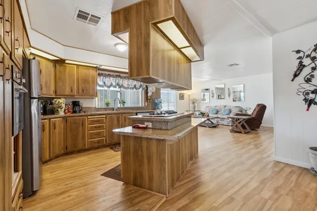 a kitchen with stainless steel appliances granite countertop a stove and a refrigerator