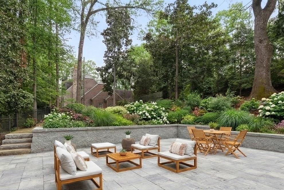 1275 The By Way Northeast Atlanta, GA 30306 - Photo 2 of 48 a swimming pool with outdoor seating and a garden