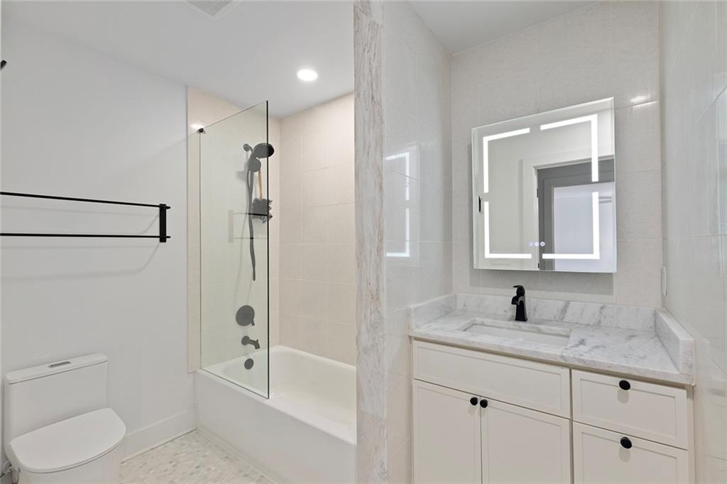 1275 The By Way Northeast Atlanta, GA 30306 - Photo 33 of 48 a bathroom with a granite countertop sink toilet and shower