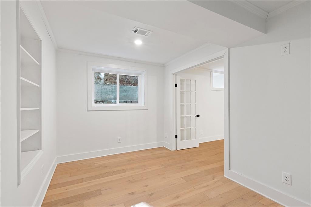 1275 The By Way Northeast Atlanta, GA 30306 - Photo 34 of 48 a view of an empty room with wooden floor and a window
