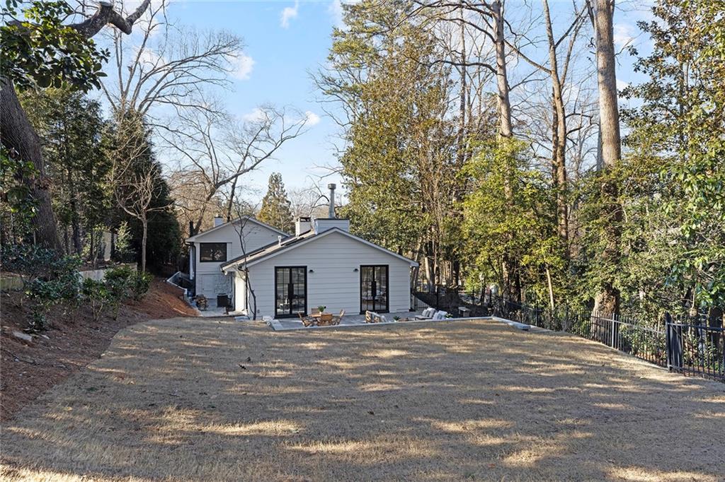 1275 The By Way Northeast Atlanta, GA 30306 - Photo 43 of 48 a front view of a house with a yard and large trees