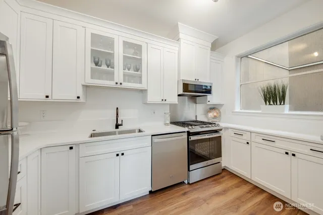 a kitchen with white cabinets and a stove