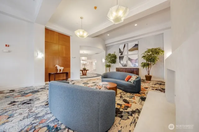 a living room with furniture and a chandelier