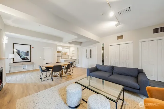 a living room with furniture and wooden floor
