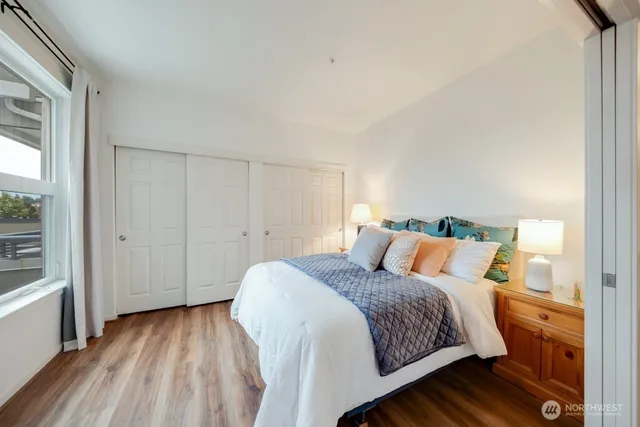 a bedroom with a bed and a wooden floor