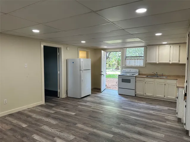 a kitchen with stainless steel appliances granite countertop a refrigerator and a stove top oven