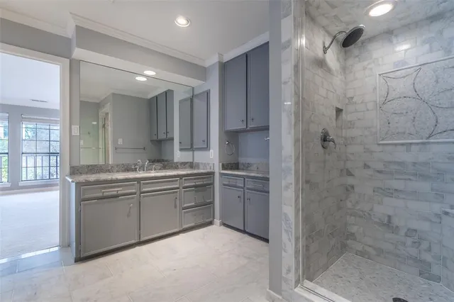 a bathroom with a granite countertop sink mirror and shower