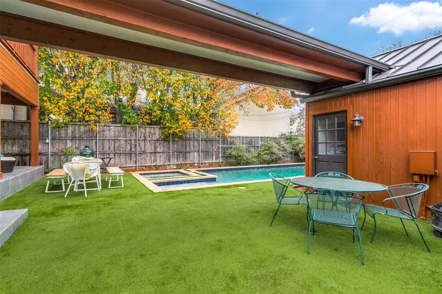 a view of backyard with a table and chairs