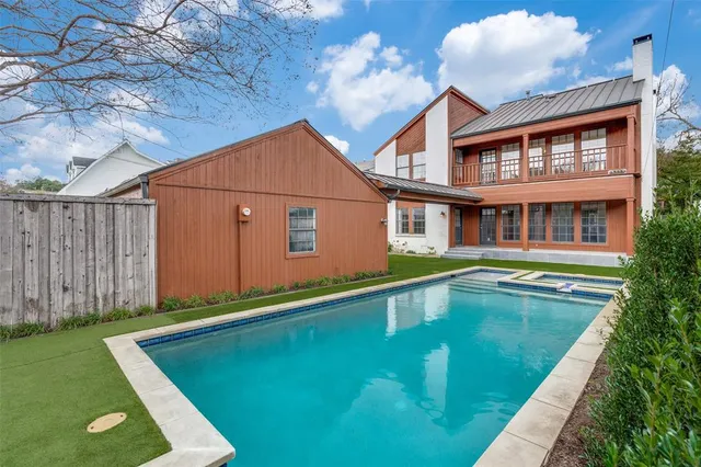 a swimming pool with yard in front of it