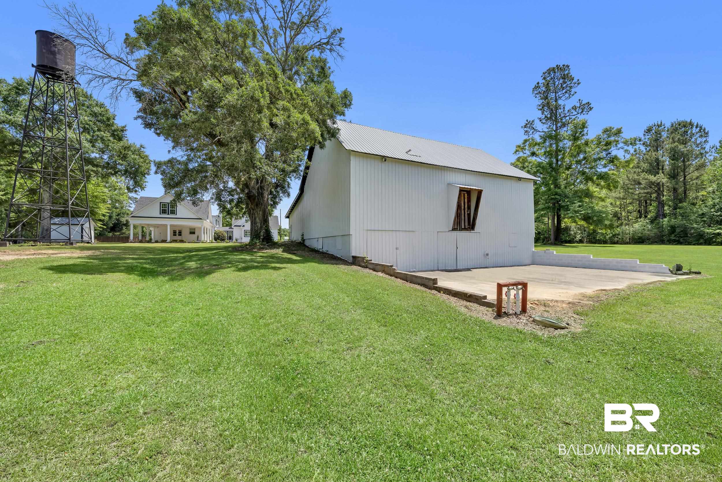 43199 Pine Grove Road Bay Minette, AL 36507 - Photo 21 of 71 White barn structure with a metal roof and a concrete pad