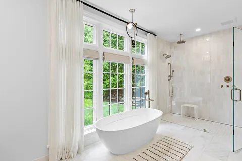 a bathroom with a bathtub and shower