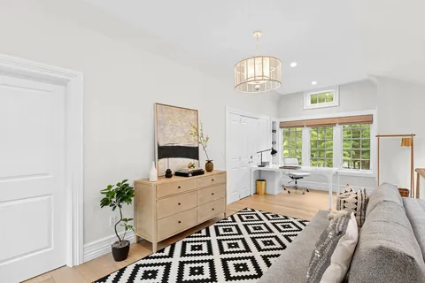 a bedroom with furniture and a window