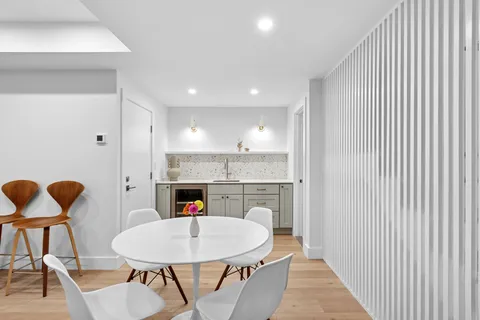a hall with dining table and chairs