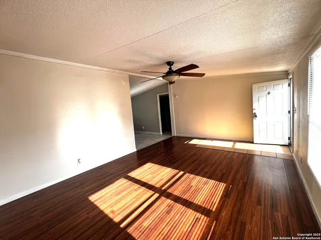 a view of a room with wooden floor and staircase