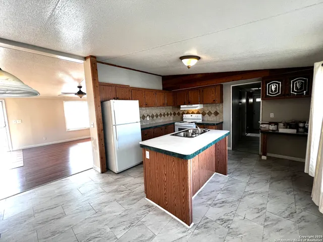 a kitchen with a refrigerator and a stove